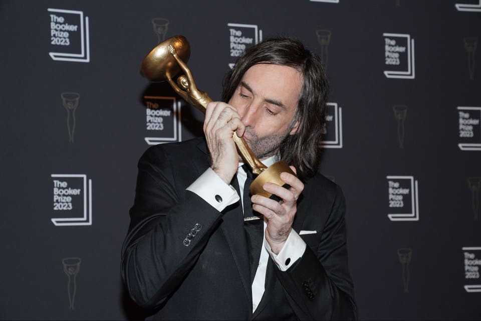 <p>Paul Lynch kisses trophy after being named as the winner of the 2023 Booker Prize for the novel Prophet Song</p>